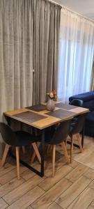 a dining room table with two chairs and a table at Karpacz Apartament Chabrowy in Karpacz