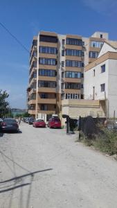 a parking lot with cars parked in front of a building at Lake View in Constanţa