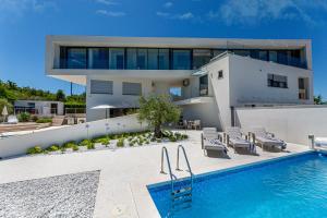 a villa with a swimming pool and a house at Villa Bianca in Vantačići