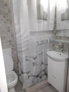 uma casa de banho branca com um WC e um lavatório em Peninsula-Cazino,Dalvi em Constança