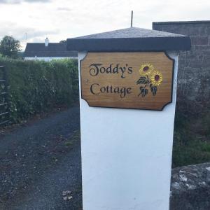 a sign for aobiologists college on a white and blue box at Toddys Cottage & Stables in Cavan