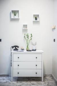 a white dresser with a plant on top of it at B&B Boteroom in Cassino