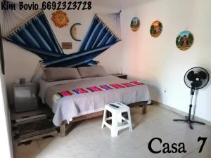 a bedroom with a large bed and a television at Casa 7 in Mazatlán