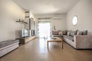 a living room with a couch and a table at Meteora's Secret Garden House#1 in Kalabaka