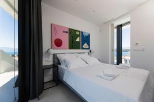 a bedroom with a white bed and a large window at Villa Bianca in Vantačići +40 photos