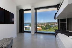 a bedroom with white walls and large windows at Villa Bianca in Vantačići
