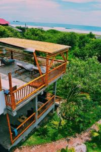 an overhead view of a house with a deck and a beach at Hermanos Perdidos Surf in Las Tunas