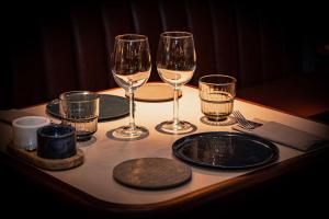 a table with wine glasses and plates on it at Radisson Blu Hotel, Madrid Prado in Madrid