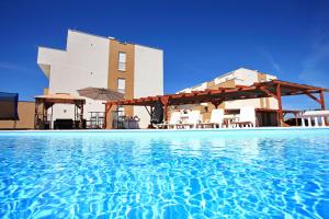 a resort with a swimming pool in front of a building at Apartment Village Nin in Nin