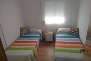 Łóżko lub łóżka w pokoju w obiekcie Aitana