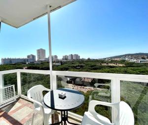 a balcony with a table and chairs and a view at GoettenMar Platja d'Aro in Platja d'Aro