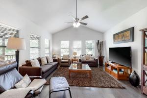 a living room with couches and a flat screen tv at Riverside Sanctuary in Boerne