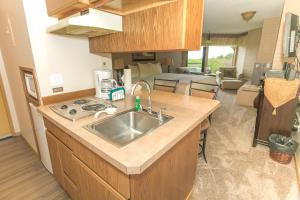 a kitchen with a sink and a living room at Grey Gull in Ocean Shores