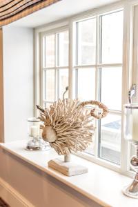 a vase on a window sill next to a window at Plum and Partridge Husthwaite in York