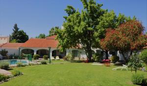a house with a yard with a swimming pool at Chenin Lodge in Ciudad Lujan de Cuyo