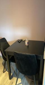 a black table with two chairs and a box on it at Mine d'Amour in Wallers +10 photos
