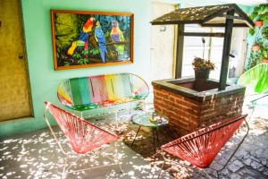 a patio with a table and chairs and an umbrella at Casa Del Pozo Boutique Hostel in Cartagena de Indias