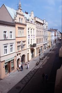 a group of people walking down a street with buildings at Apartamenty Długa 6 in Bydgoszcz