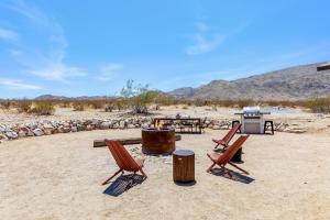 a group of chairs and a grill in the desert at 1 Minute To Joshua Tree National Park, Hot Tub, Stars, Private - The WKNDR in Twentynine Palms