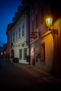 a building with a light on the side of a street at Pension U Lilie in Prague