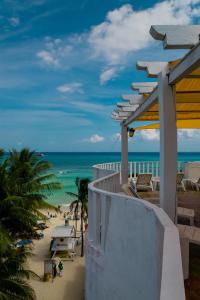 a view of the beach from the balcony of a resort at Hotel Kay Adults Only in Playa del Carmen