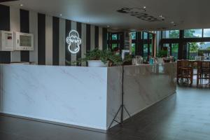 a large white counter in a room with tables and chairs at Blu Monkey Hub and Hotel Chanthaburi in Chanthaburi