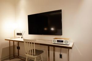 a tv on a table with a chair and a radio at 9 Brick Hotel in Seoul