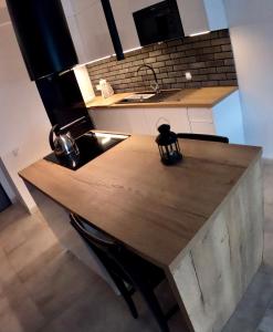a kitchen with a wooden counter top and a sink at Apartment 2-Rooms-Garage-TV-Wifi in Poznań
