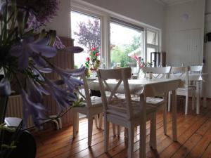 een eetkamer met een witte tafel en stoelen bij B&B Sagenland in Harbrinkhoek