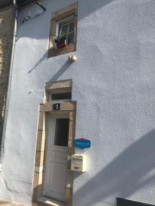 a white building with a door and a window at Le Gîte des Lumières in Langres