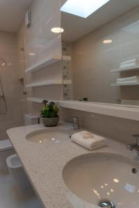a bathroom with a sink and a mirror at Garden - Casa Sao Joao - 4 Star Tourist Apartments in Angra do Heroísmo
