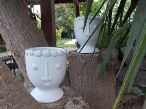 a couple of white vases sitting in trees at Oasi di Campagna in Modica