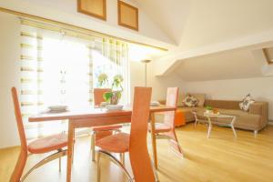 - une salle à manger et un salon avec une table et des chaises dans l'établissement Appartement Unterweger, à Sankt Niklas an der Drau