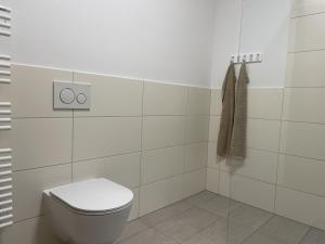 biała łazienka z toaletą i ręcznikiem w obiekcie Grimmingblick Apartment 206 by AA Holiday Homes w mieście Tauplitz +10 zdjęć