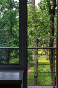 an open window with a view of a tree at Aurora Park Hotel in Vladivostok