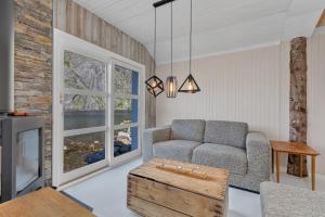a living room with a couch and a table at Lofoten Cottages in Nusfjord