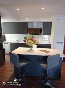 a kitchen with a island with a vase of flowers on it at Amplio apartamento Marbella in Marbella