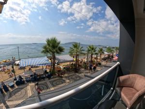 a balcony with a view of a beach and the ocean at avsa extra vagant hotel in Avşa Adası