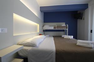 a bedroom with a large bed with a blue wall at Hotel Desire' in Riccione