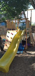 a playground with a slide in a park at AlmaVille Mamaia in Mamaia Nord
