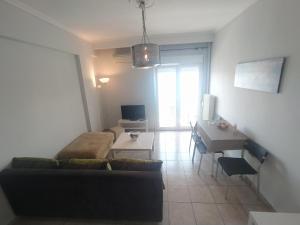 a living room with a couch and a table and a desk at Traveler Homes 2 in Kavála