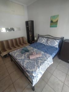a bedroom with a bed with a blue and white comforter at Traveler Homes 2 in Kavála