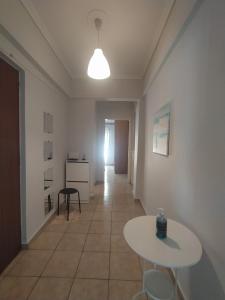 a hallway with a table and chairs in a room at Traveler Homes 2 in Kavála +13 photos
