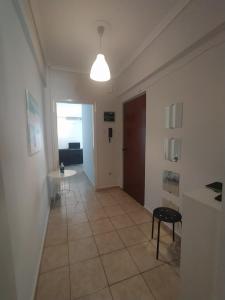 a hallway with a room with a table and a light at Traveler Homes 2 in Kavála
