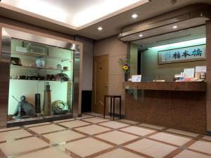 a lobby with a counter and a display case at Hotel Hashimotorou in Ishioka