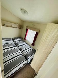 a small room with two beds in a trailer at Lakeside Holiday Rentals - Delta in Great Billing