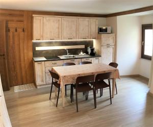 cocina con mesa y sillas en una habitación en Résidence Château Royal, en Cogne