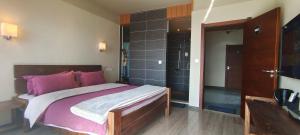 a bedroom with a large bed and a walk in shower at Beyond The Cloud in Yuanyang