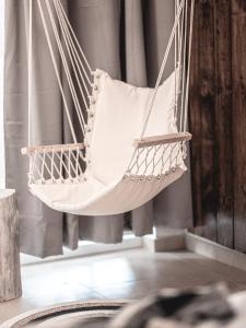 a white hammock hanging in a room at La Finca - Saint Vlas in Sveti Vlas