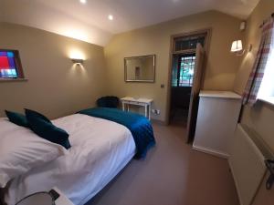 a hotel room with two beds and a window at Coach House, Minting. in Horncastle